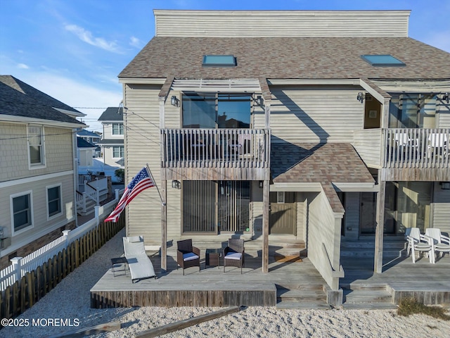 rear view of property featuring a deck and outdoor lounge area