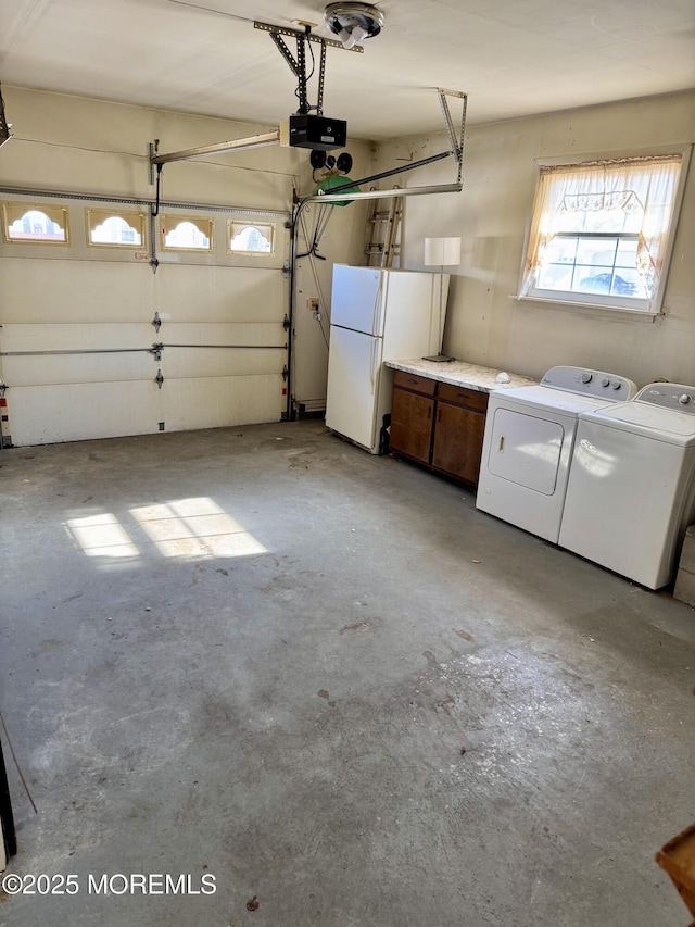 garage with a garage door opener, white refrigerator, and separate washer and dryer