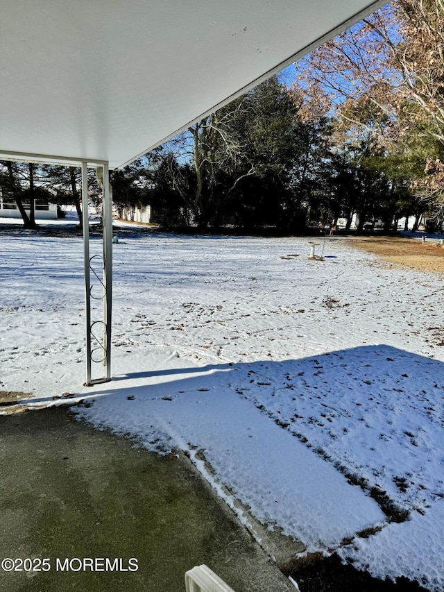 view of yard layered in snow