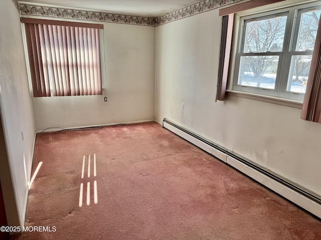 spare room featuring carpet and a baseboard radiator