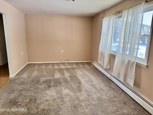 empty room with a baseboard radiator, a healthy amount of sunlight, and carpet floors