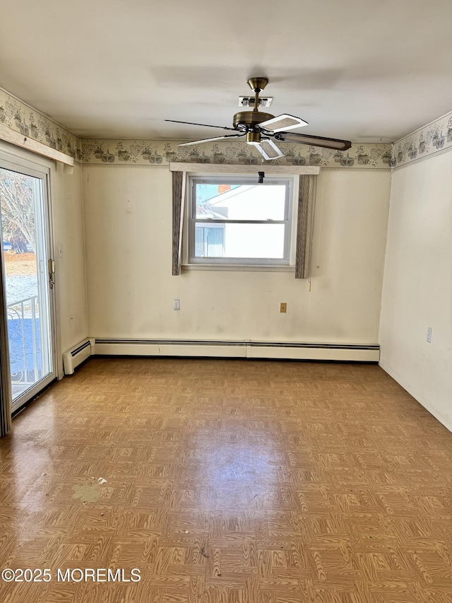 spare room featuring ceiling fan, a wealth of natural light, and light parquet flooring