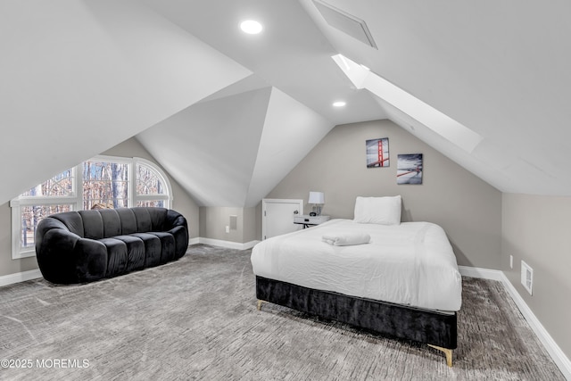 carpeted bedroom with vaulted ceiling with skylight