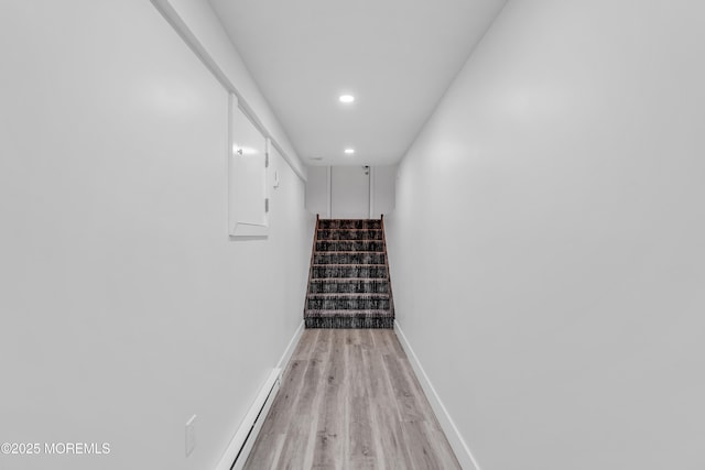 stairway featuring wood-type flooring