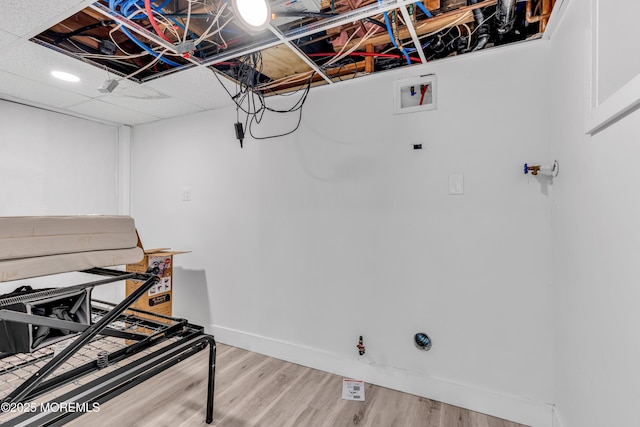 clothes washing area featuring hookup for a washing machine and hardwood / wood-style flooring