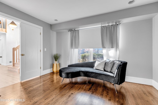 sitting room with wood-type flooring