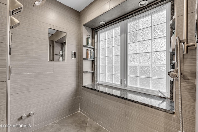 bathroom with a shower and tile patterned flooring