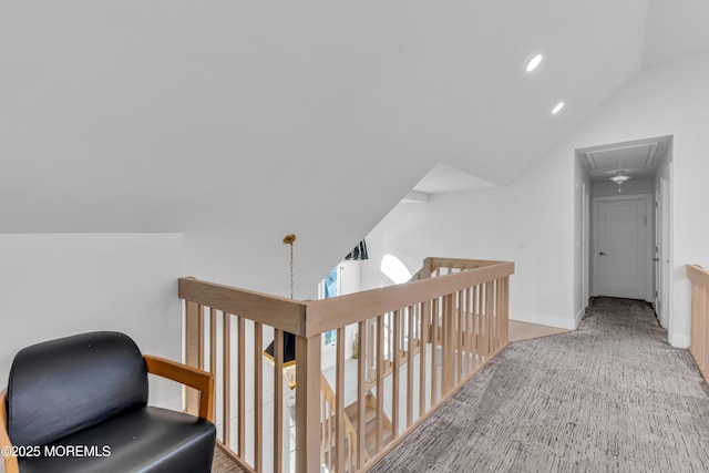 hallway with light colored carpet and lofted ceiling