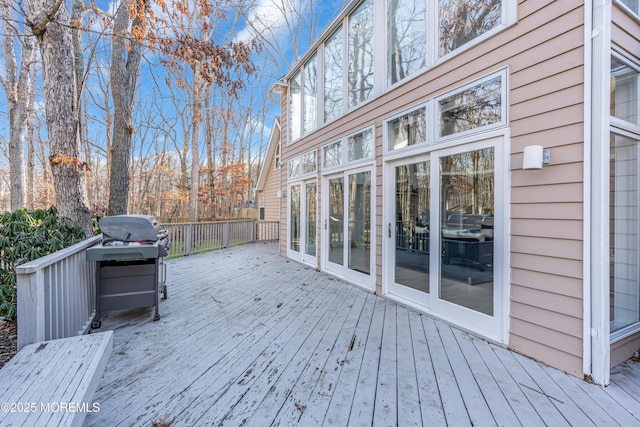 wooden terrace with a grill