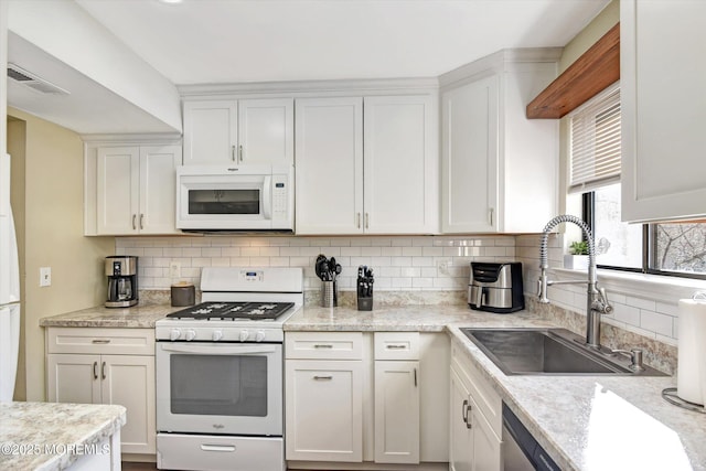 kitchen with white cabinetry, sink, and white appliances