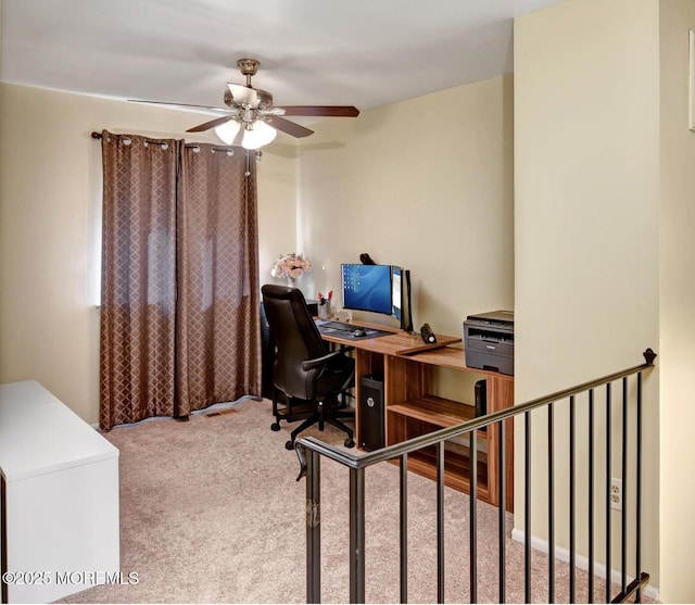 carpeted home office with ceiling fan