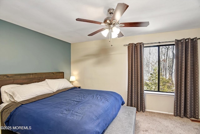 bedroom with light carpet and ceiling fan