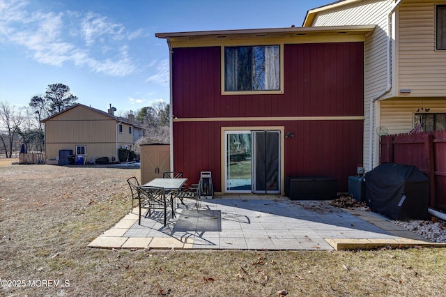 back of property with a patio