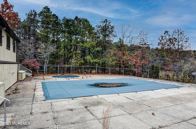 view of swimming pool featuring a jacuzzi and a patio area