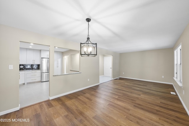 15B Betsy Ross Dr Unit B, Monroe, NJ 08831 - unfurnished living room featuring a notable chandelier and dark hardwood / wood-style flooring