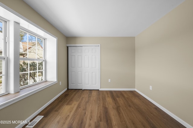 15B Betsy Ross Dr Unit B, Monroe, NJ 08831 - unfurnished bedroom featuring dark wood-type flooring, multiple windows, and a closet