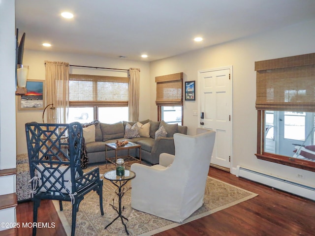 living room featuring baseboard heating and dark hardwood / wood-style floors