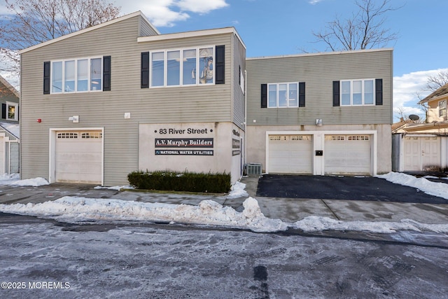 view of front of home featuring a garage and central AC unit