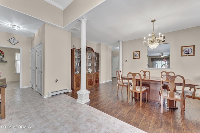 dining space featuring a baseboard radiator, decorative columns, light wood-type flooring, and ceiling fan