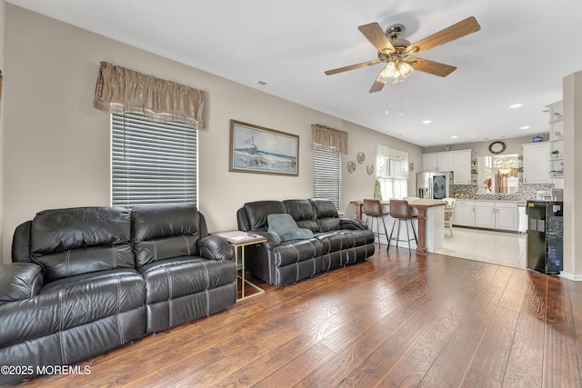 living room with hardwood / wood-style flooring and ceiling fan