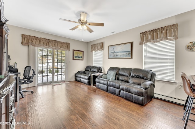 living room with hardwood / wood-style flooring, ceiling fan, and baseboard heating