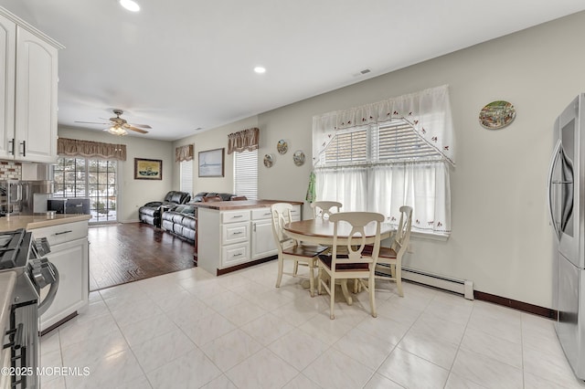 dining room with ceiling fan and light tile patterned flooring