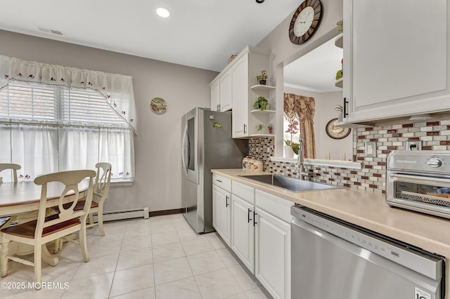 kitchen featuring white cabinetry, decorative backsplash, sink, stainless steel appliances, and light tile patterned flooring