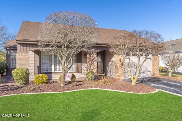 view of front facade with a garage and a front lawn