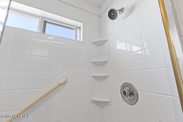 bathroom with tiled shower