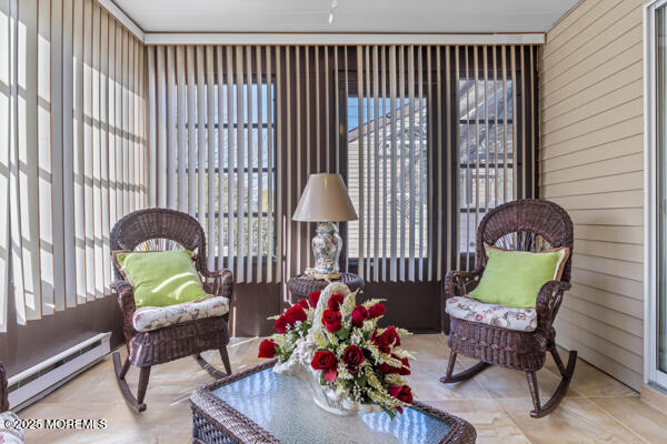 sunroom featuring a baseboard radiator