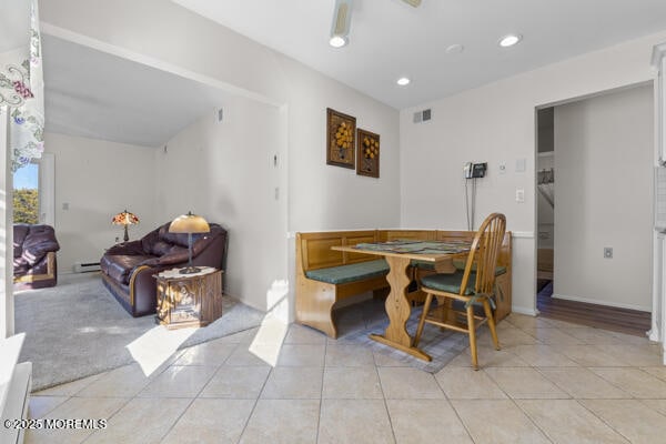 tiled dining space featuring ceiling fan