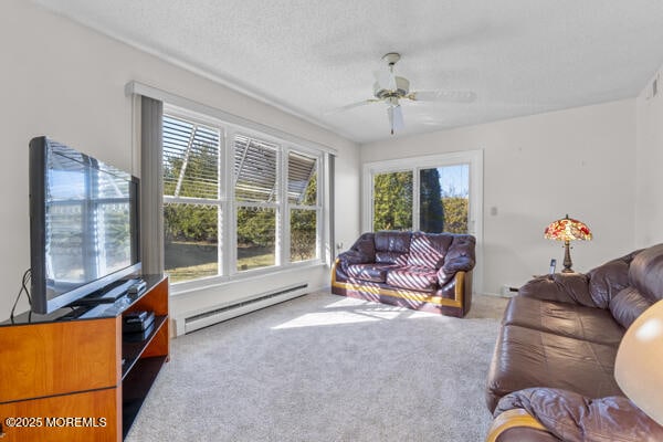 carpeted living room with a baseboard heating unit, a textured ceiling, and ceiling fan