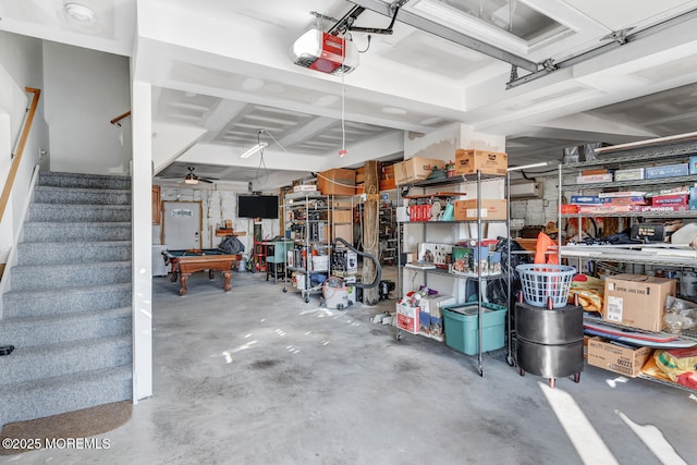 garage featuring ceiling fan and a garage door opener