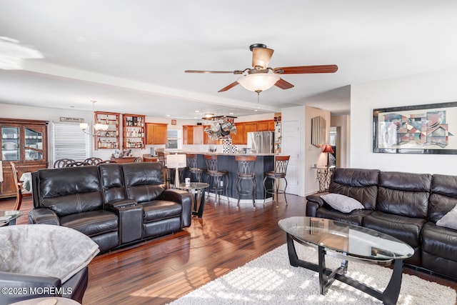 living room with ceiling fan and dark hardwood / wood-style flooring