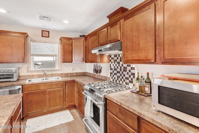 kitchen with sink, light tile patterned floors, and appliances with stainless steel finishes