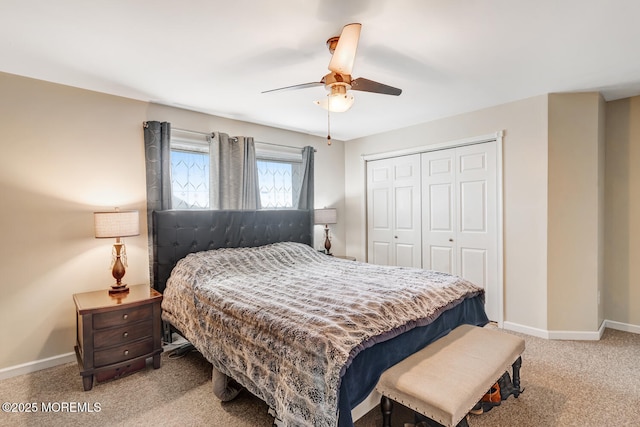 carpeted bedroom featuring ceiling fan and a closet