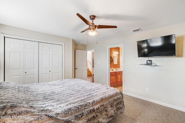 bedroom featuring ceiling fan, ensuite bathroom, a closet, and carpet floors