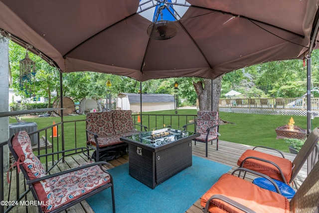 view of patio / terrace with an outdoor fire pit, a gazebo, a deck, and central AC