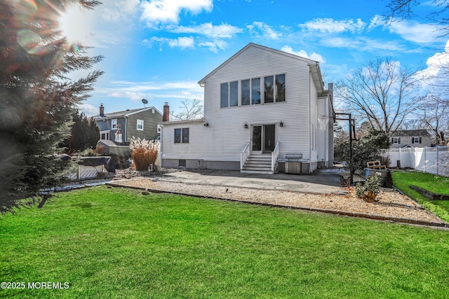 rear view of house with a lawn and a patio