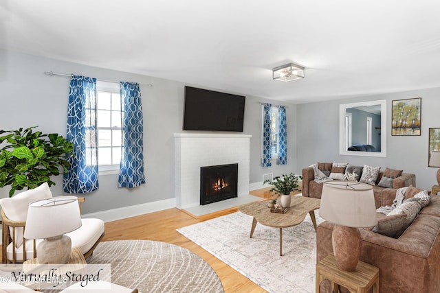 living room featuring a fireplace and light wood-type flooring