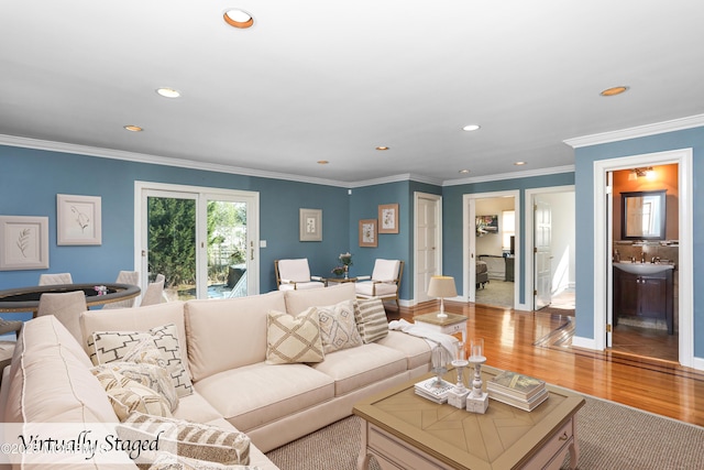 living room featuring crown molding and light hardwood / wood-style flooring