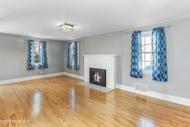 unfurnished living room featuring hardwood / wood-style floors and a fireplace