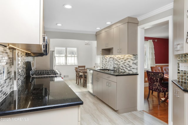 kitchen with sink, crown molding, stainless steel dishwasher, dark stone counters, and backsplash