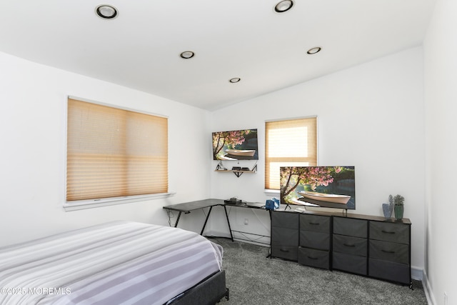 carpeted bedroom with lofted ceiling