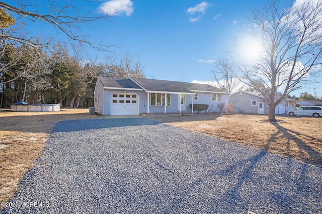 ranch-style house with a garage and a covered pool