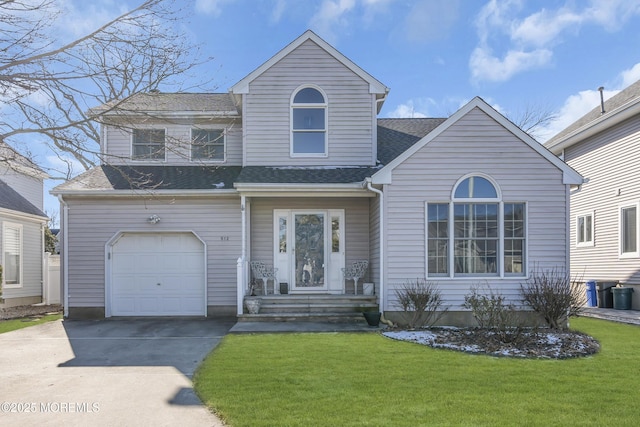 view of front of home with a garage and a front lawn