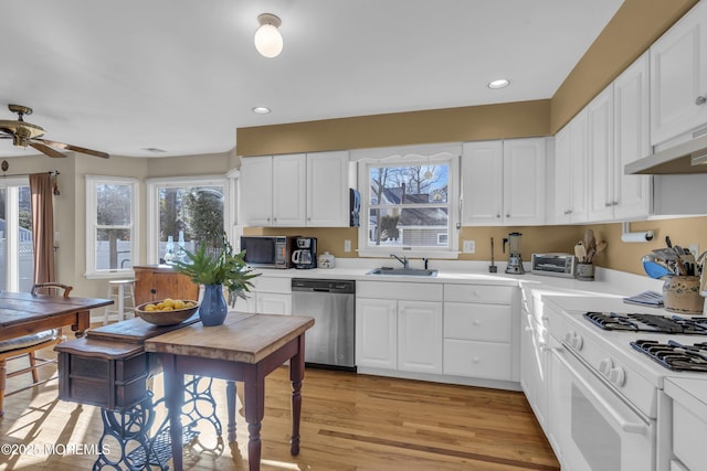 kitchen with sink, light hardwood / wood-style flooring, white cabinets, white range with gas cooktop, and stainless steel dishwasher