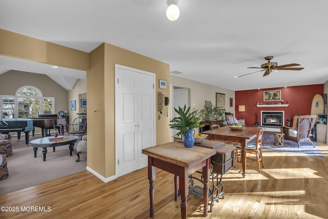 dining space featuring ceiling fan, vaulted ceiling, and light hardwood / wood-style floors