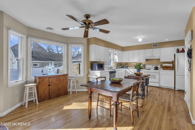 dining room featuring light hardwood / wood-style flooring and ceiling fan