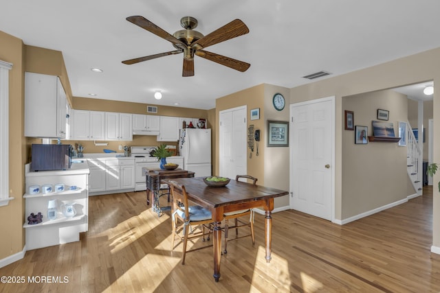 dining area with ceiling fan and light hardwood / wood-style flooring